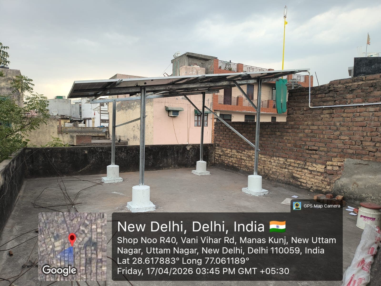 Solar panels on a raised galvanised structure with painted concrete footings on a New Delhi house rooftop